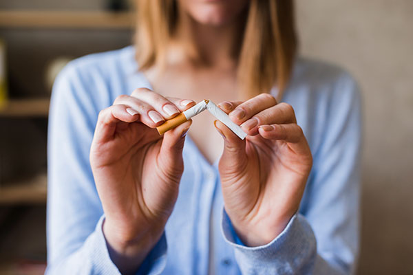 female-hand-breaking-cigarette female-hand-breaking-cigarette